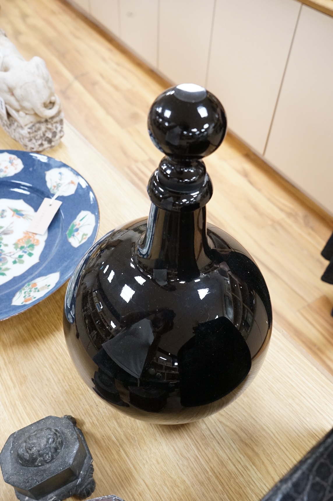 A late 19th / early 20th century dark amethyst pharmacy jar with stopper, 39cm high